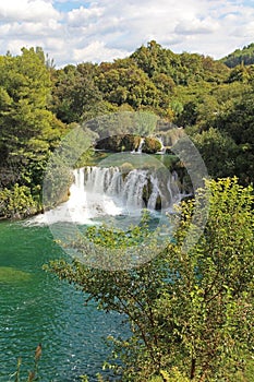 Krka National Park with a beautiful Skradinski Buk waterfall in early autumn, famous travel destination in Dalmatia of Croatia.