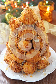 Krokembush cake on a table with Christmas decorations and candle