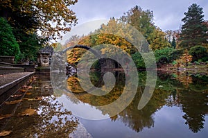 Kromlau Azalea and Rhododendron Park in autumn, the Rakotz Bridge reflecting on the water, Germany,