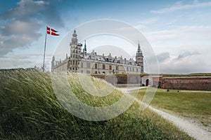 Kronborg Castle and the flag of Denmark known as Dannebrog - Helsingor, Denmark photo