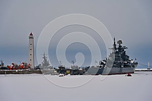 Kronstadt frozen bay with exhibition of warships and lighthouse