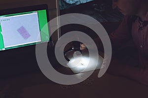 Portable USB Digital Microscope connected to a laptop. Man examines biological tissue