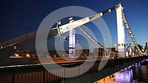 Krymsky Bridge or Crimean Bridge and traffic of cars (night)-- is a steel suspension bridge in Moscow, Russia