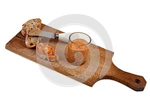 Ktipiti in a verrine on a cutting board with toast and a knife on white background