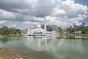 Kuala Ibai Floating Mosque or Masjid Tengu Tengah Zaharah and its reflection in the water. photo
