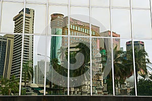 Reflection of the office buildings in the modern building windows in Kuala Lumpur, Malaysia.