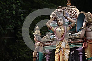 KUALA LUMPUR, MALAYSIA - AUGUST 23, 2013: Statues of Hindu deities in the temple of Batu Caves.