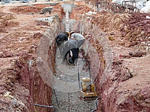Underground sewerage pipe installed by construction workers at the construction site.