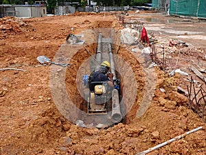 Underground sewerage pipe installed by construction workers at the construction site.