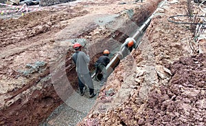 Underground sewerage pipe installed by construction workers at the construction site.