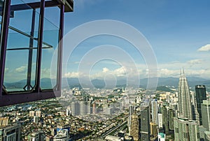 KUALA LUMPUR / MALAYSIA - JANUARY 2019: Impressive city aerial view at Skybox transparent glass balcony in Menara KL tower, a