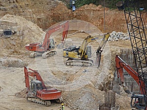 Heavy construction machines doing building foundation works at the construction site.