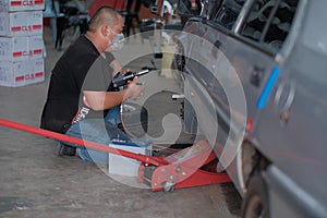 Tyre change on the car in a workshop by a mechanic