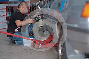 Tyre change on the car in a workshop by a mechanic