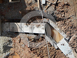 Underground drainage manhole under construction by construction workers at the construction site.