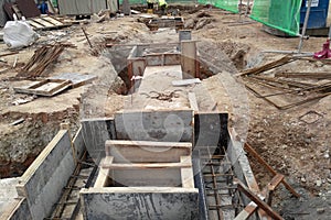 Underground drainage manhole under construction by construction workers at the construction site.