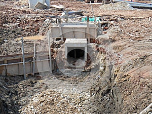 Underground drainage manhole under construction by construction workers at the construction site.