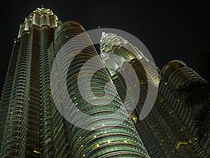 KUALA LUMPUR / MALAYSIA - 2019 : Night view of the impressive Petronas twin towers at Kuala Lumpur KLCC area