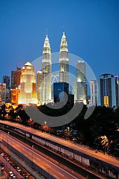 Kuala Lumpur skyscraper night scenery during blue hour.