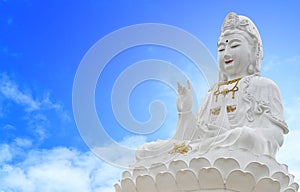 Kuan Yin buddha on sky background