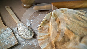 Kuboos or khubz - Arabic bread on a brown table in the kitchen