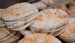 Kuboos or khubz - fresh pita bread togeather in a table