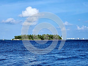 Kuda Bandos Island with Male in the background, Maldives