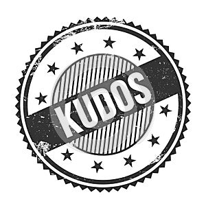 KUDOS text written on black grungy round stamp