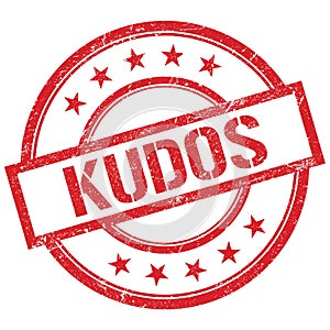 KUDOS text written on red vintage stamp