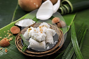 Kue Putu, Indonesian Traditional Cake Made from RIce Flour, Palm SUgar, Pandan Leaf, and Shredded Coconut photo