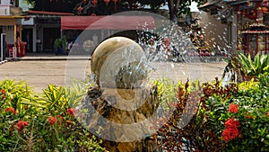 A Kugel Fountain spraying water over plants