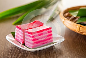 Kuih lapis is a traditional Malay nyonya sweet desert on wooden table