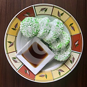 Kuih Lopes and syrup on a round plate. Square photo image.