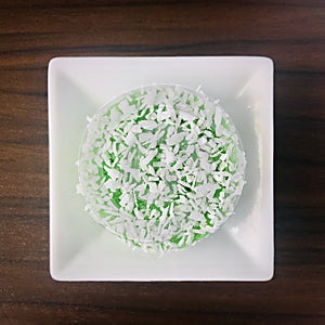 A Kuih Lopes on a white square plate.