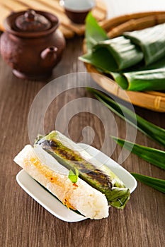 Kuih Pulut Panggang grilled glutinous rice wrapped in banana leaf with stuffed savory fillings