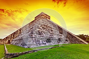 Kukulkan pyramid in Chichen Itza at sunset photo