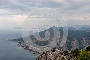 Kula - Scenic aerial view of coastal town Omis surrounded by Dinara mountains in Split-Dalmatia, South Croatia. Hiking trail