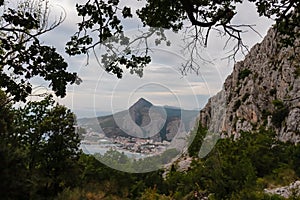 Kula - Scenic aerial view of coastal town Omis surrounded by Dinara mountains in Split-Dalmatia, South Croatia. Hiking trail