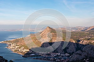 Kula - Scenic aerial view of coastal town Omis surrounded by Dinara mountains in Split-Dalmatia, South Croatia. Hiking trail