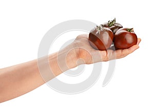kumato tomato in hand path isolated photo