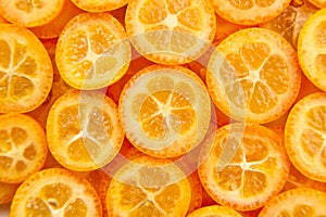 Kumquat citrus fruit slices background