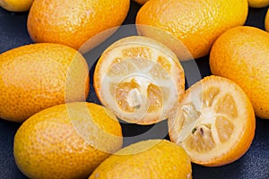 Kumquat fruits (or cumquats) citric fruit on a cup of glass.