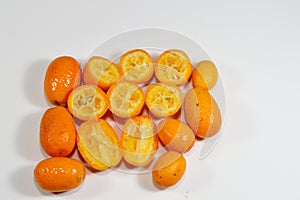 Kumquats, cumquats, a group of small, angiosperm, fruit-bearing trees in the family Rutaceae, golden orange, an edible fruit