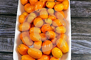 Kumquats, cumquats, a group of small, angiosperm, fruit-bearing trees in the family Rutaceae, golden orange, an edible fruit