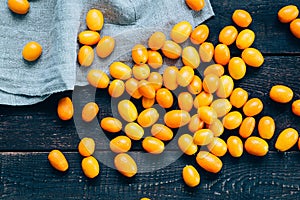 Kumquats on Dark Wooden Background, Top View, Vintage Filter