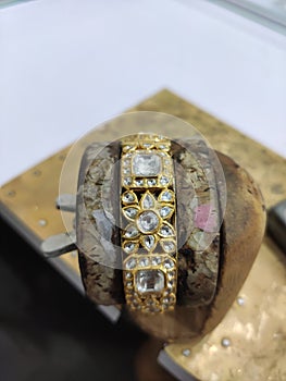 Kundan jewellery art work on gold kada bangles photo