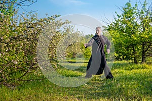 A kung fu master practiing tai taijiquan a wild garden