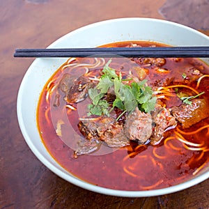 Kung fu noodles like spicy noodle with beef, vegetables and chinese sauce, Chinese traditional cuisine