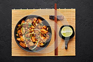 Kung Pao Chicken or Gong Bao Ji Ding at dark slate background. Sichuan Kung Pao is chinese cuisine dish
