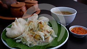 Kupat Tahu is made from fried ketupat, tofu, cabbage and bean sprouts, mixed with peanut sauce and soy sauce.